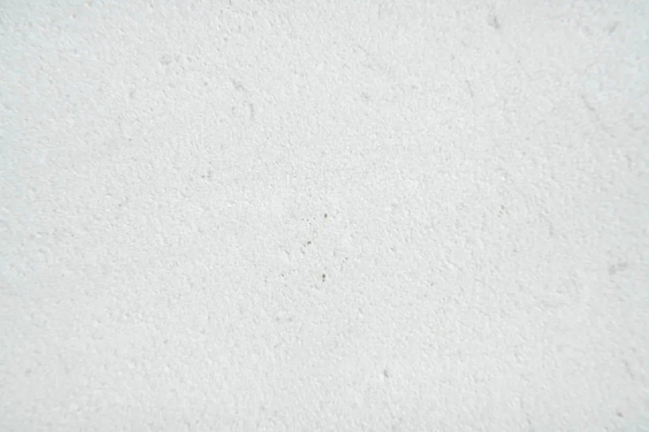 Close-up detail of the fine, matt surface of sandblasted Trani marble