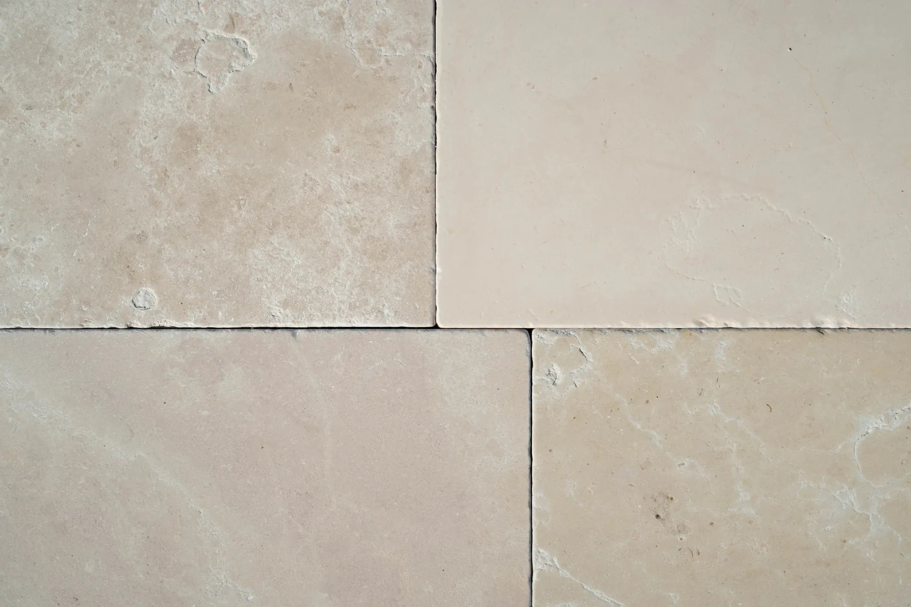 Close-up of shade-varied white marble slabs in ivory tones that differ from one another